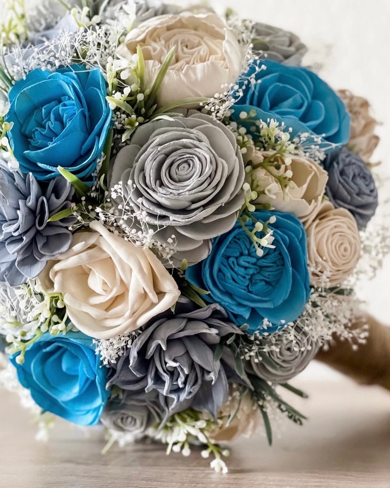 Bouquet of blue, gray, and white flowers on a blurred background