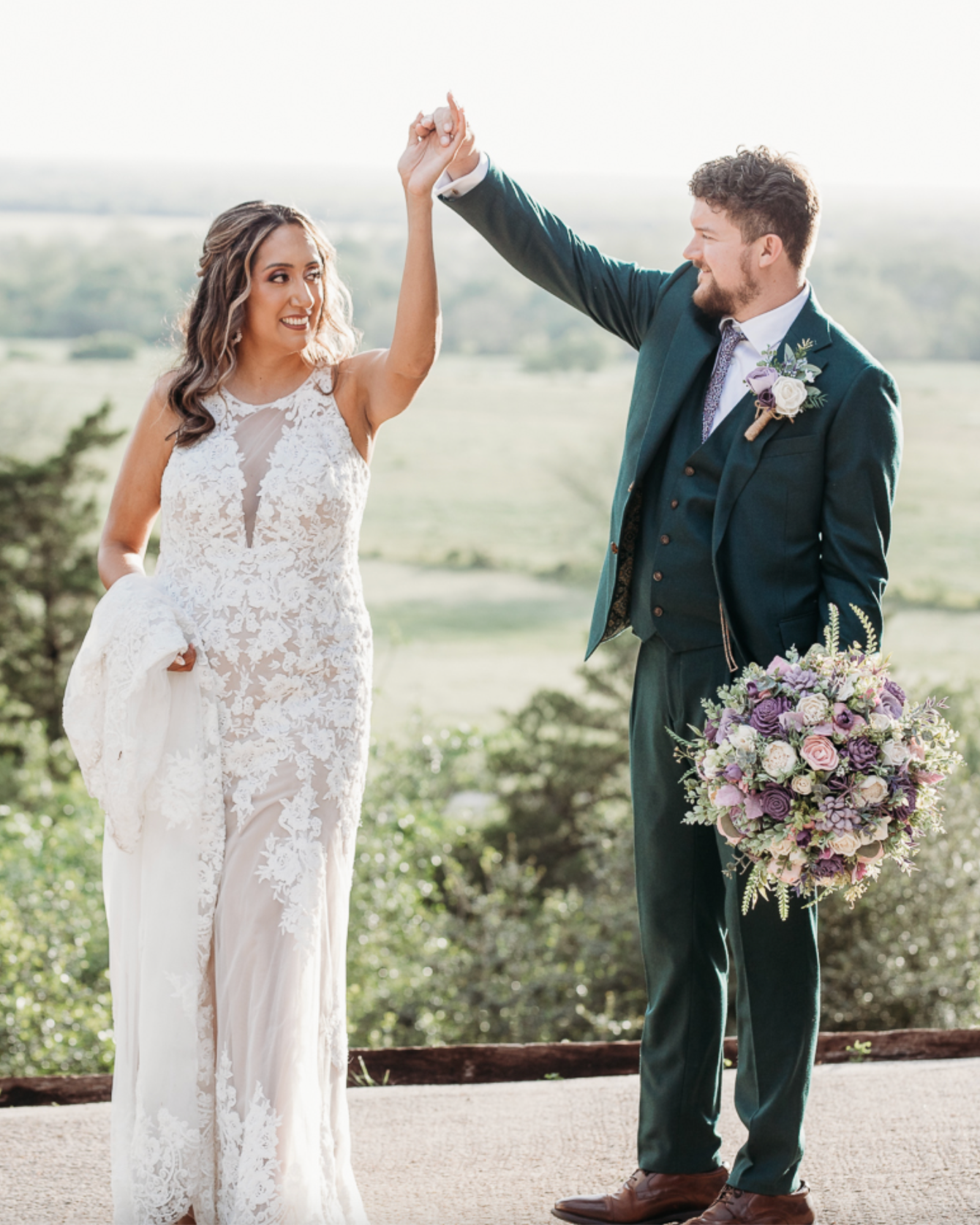 Couple in wedding attire with a scenic background
